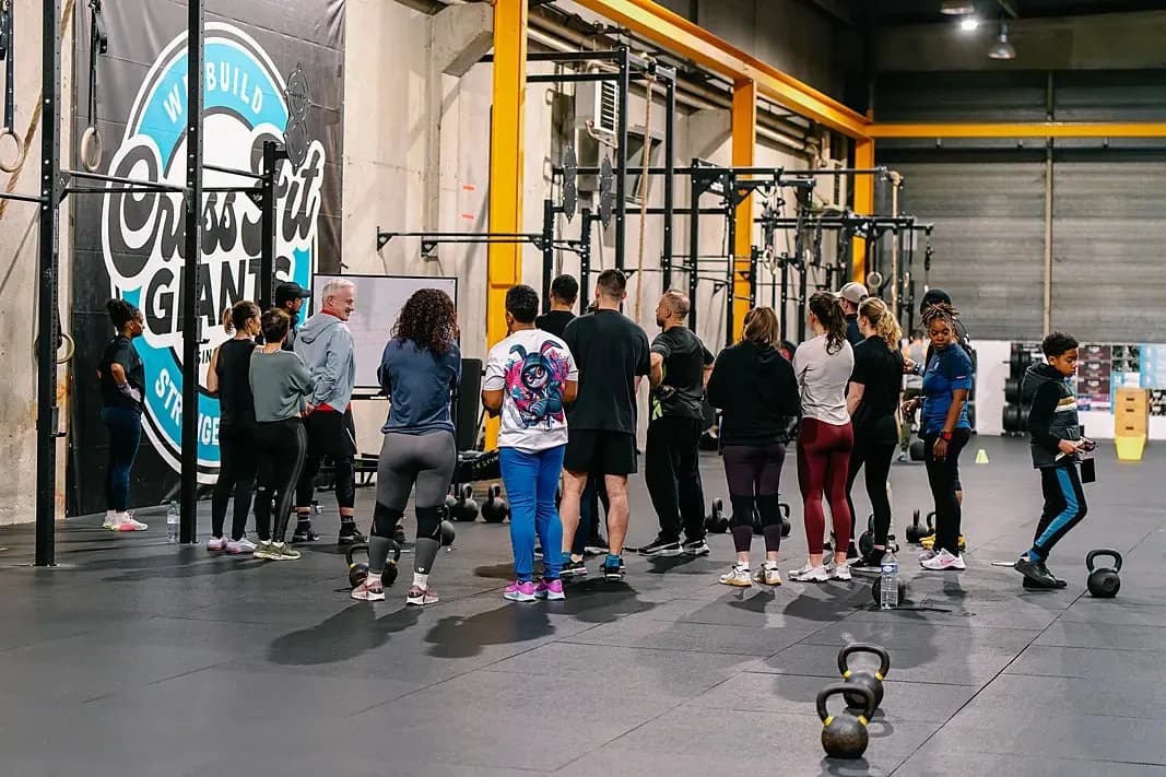 Cours collectif devant le mur de marque CrossFit Giants